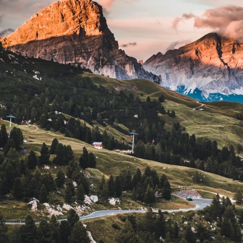 vertical-shot-of-the-dolomites-surrounded-by-green-2025-02-11-18-00-53-utc